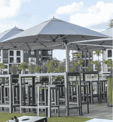 Outdoor seating with navy umbrellas in active social setting